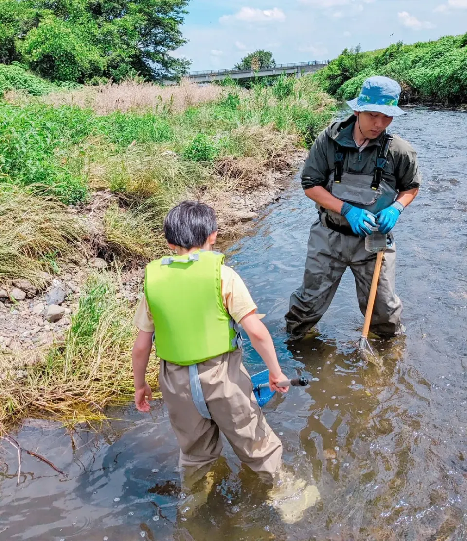 川でガイドと生き物を探す長男